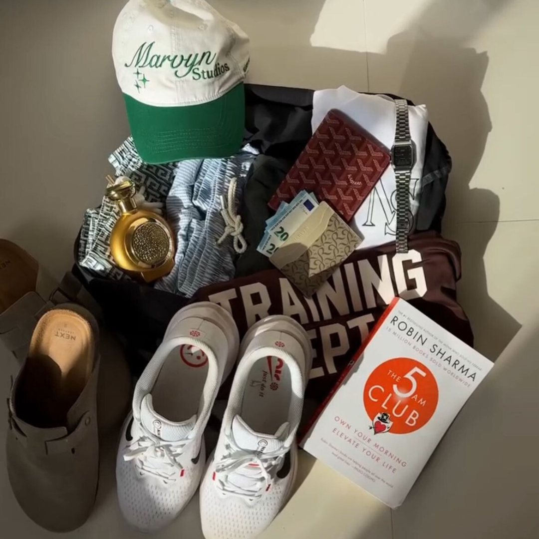 Collection of items including a hat, shoes, and a book on a surface.